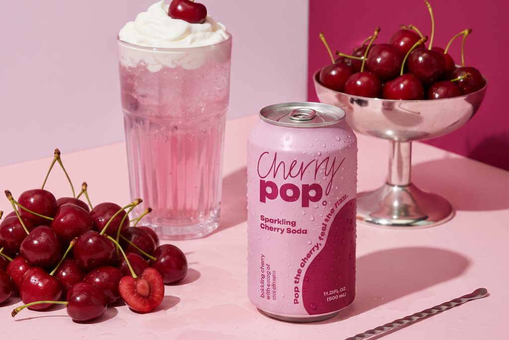 Cherry Pop sparkling cherry soda, pink editorial still life with cherry sundae and bowl of cherries