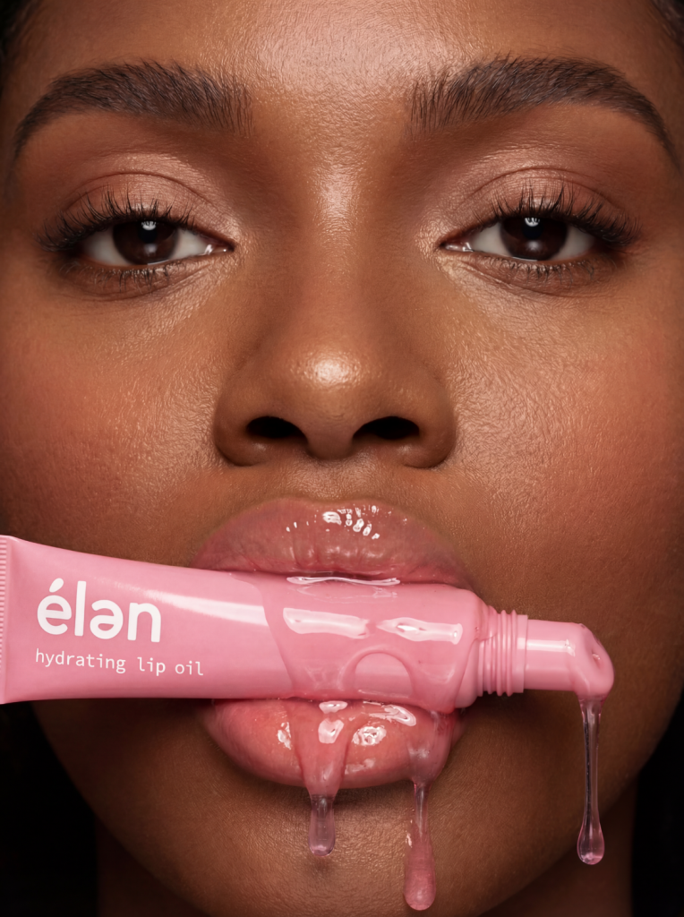 élan hydrating lip oil, close-up of model with glossy lips and dripping pink tube