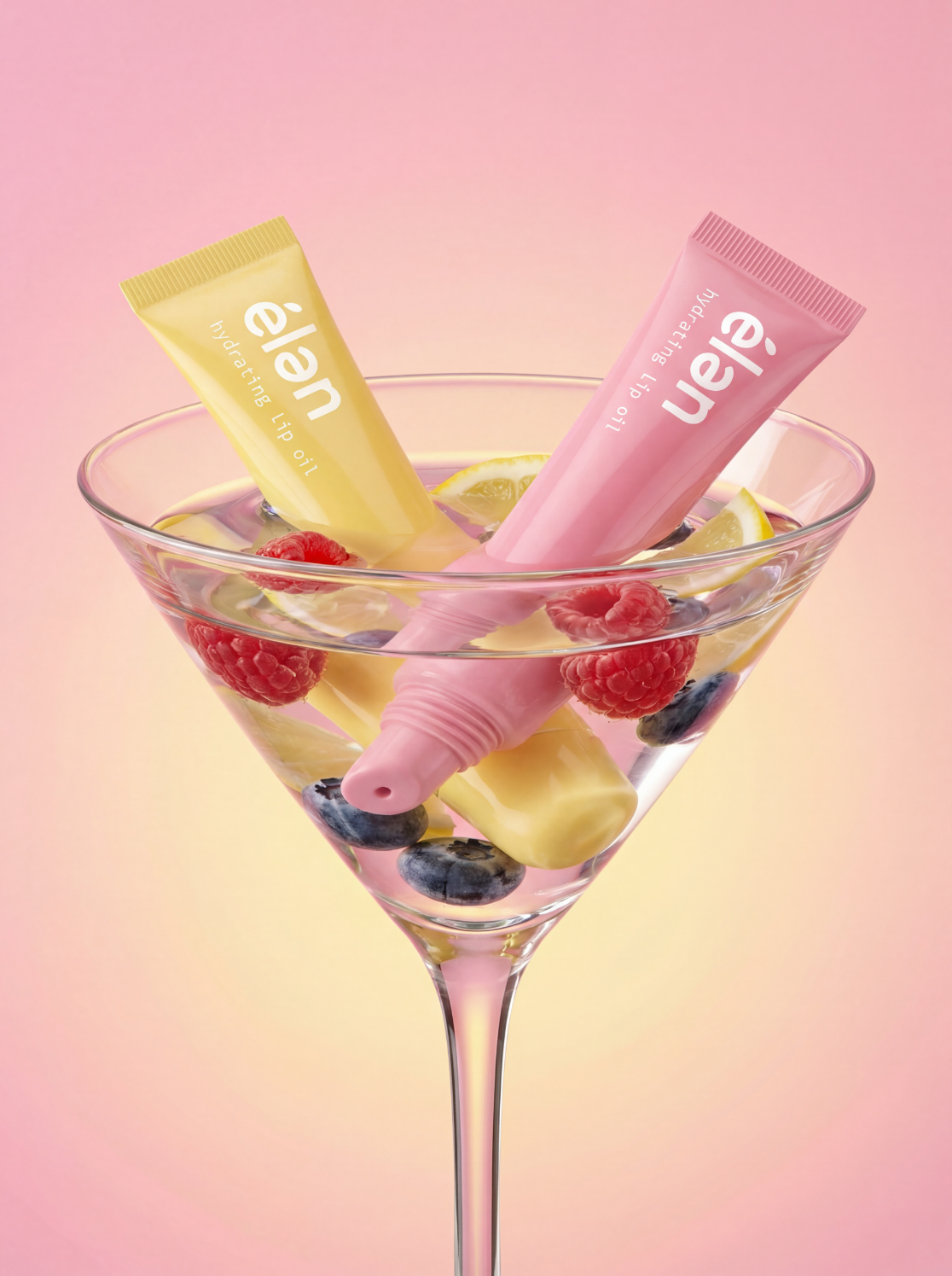 élan lip oils chilling in a martini glass with raspberries and lemon, campaign art direction