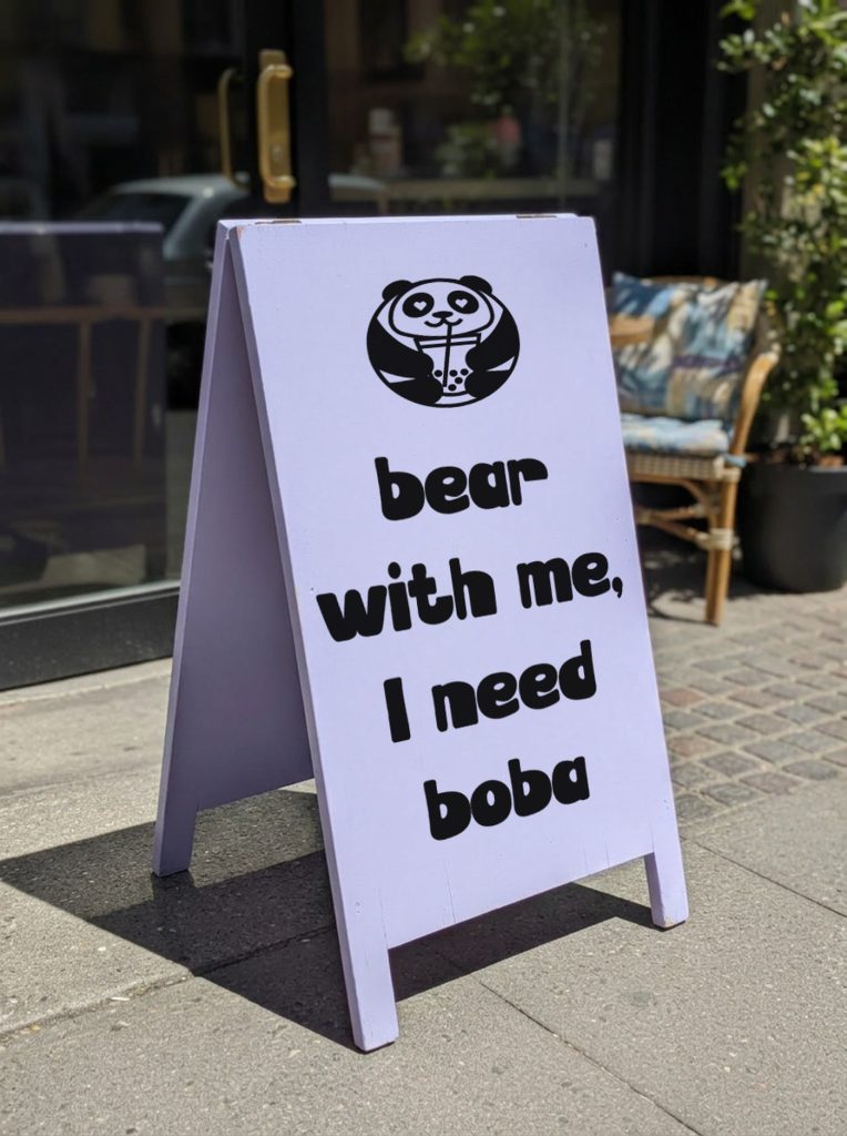 Poba Boba lilac pavement sign with the panda mark and the brand tagline